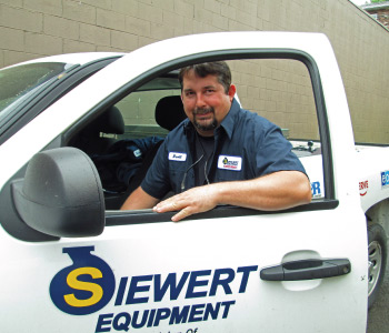 Siewert Equipment service technician with service truck,