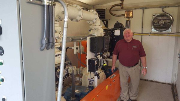 Town of Farmington Water & Sewer Superintendent standing inside a Gorman-Rupp above ground pump lift station. 