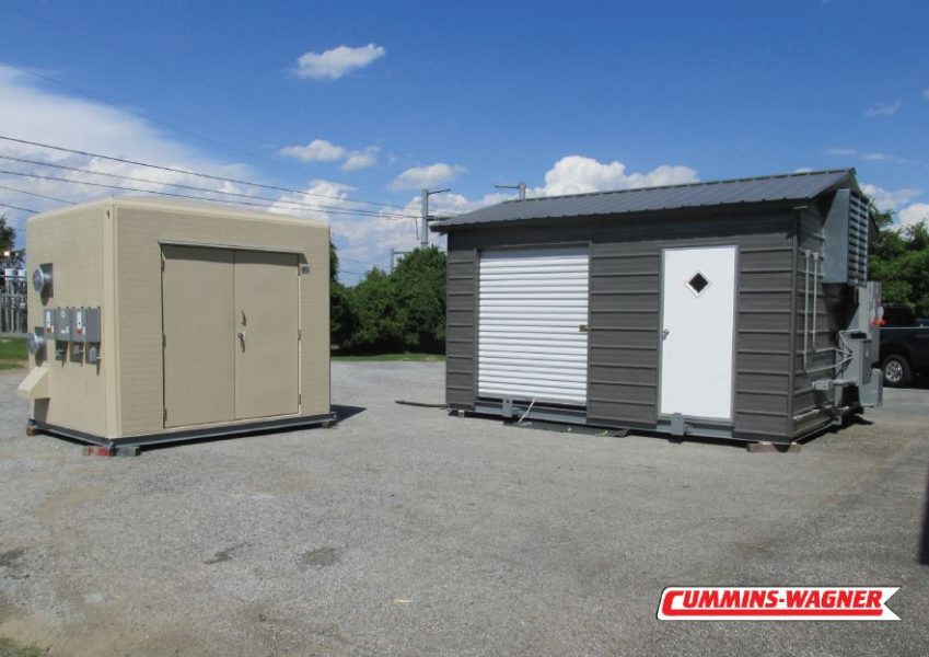 Weatherproof custom fiberglass enclosure next to a painted metal building with exterior process connections.