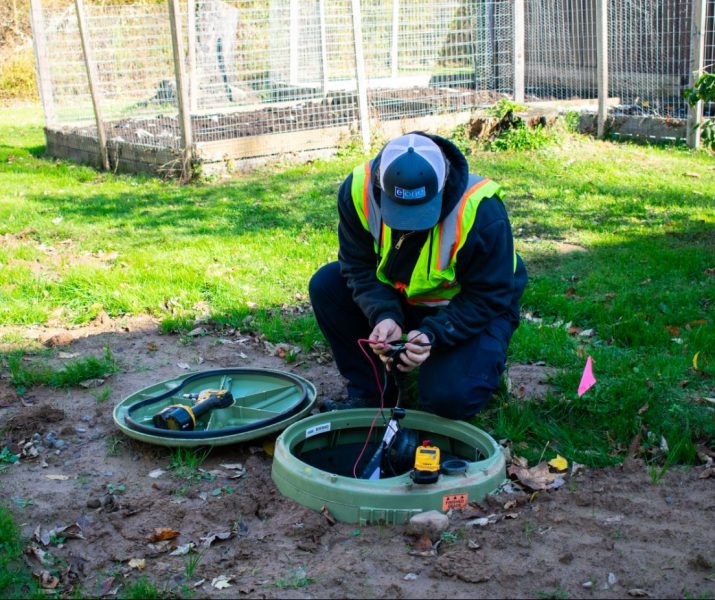 Siewert Equipment service technician working on an E/one grinder pump startup on-site