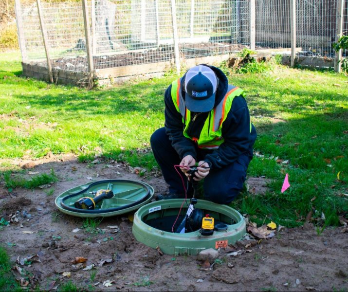 Siewert Equipment service technician working on an E/one grinder pump startup on-site